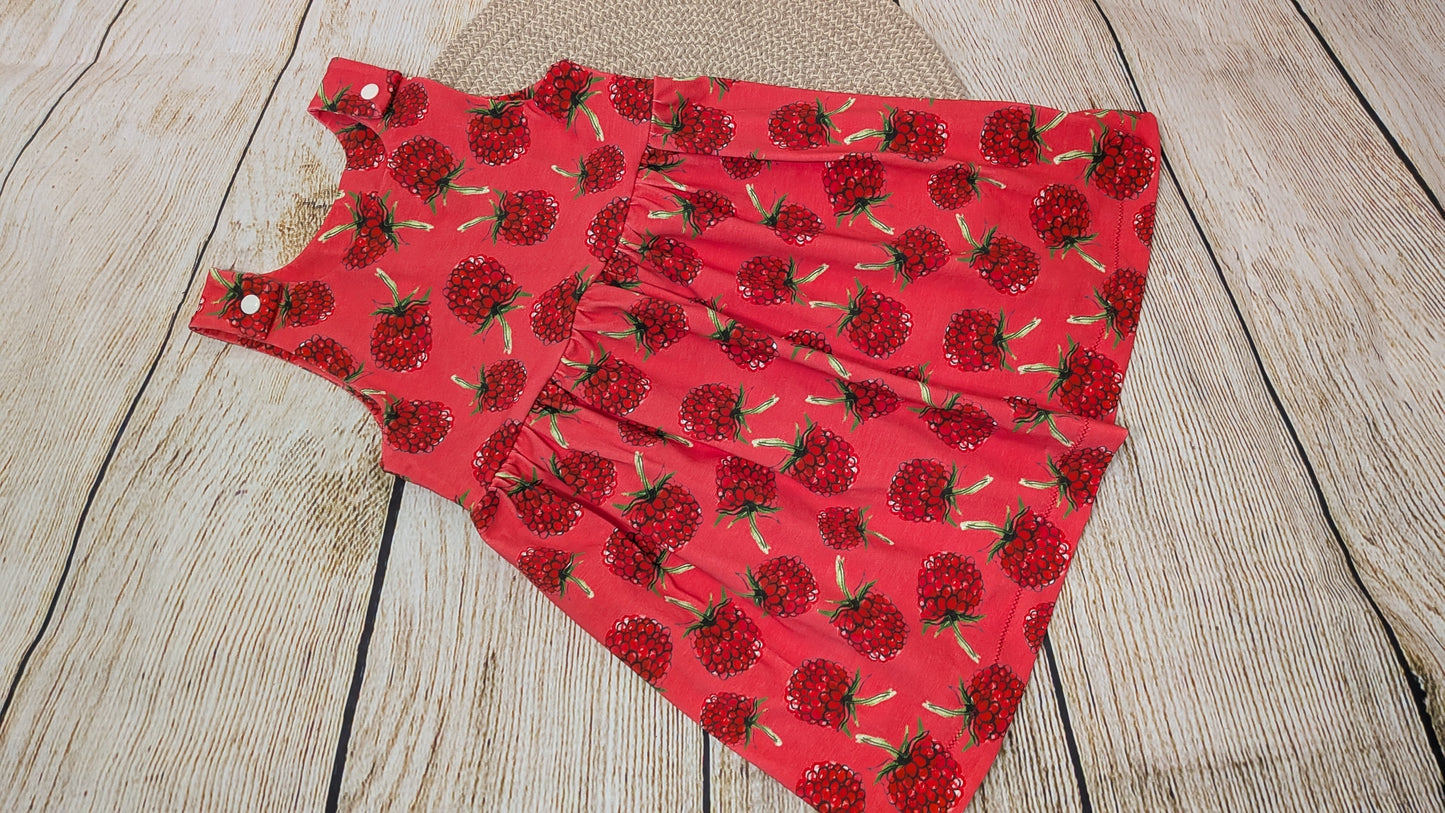 Red fabric with raspberry pattern on a wooden surface